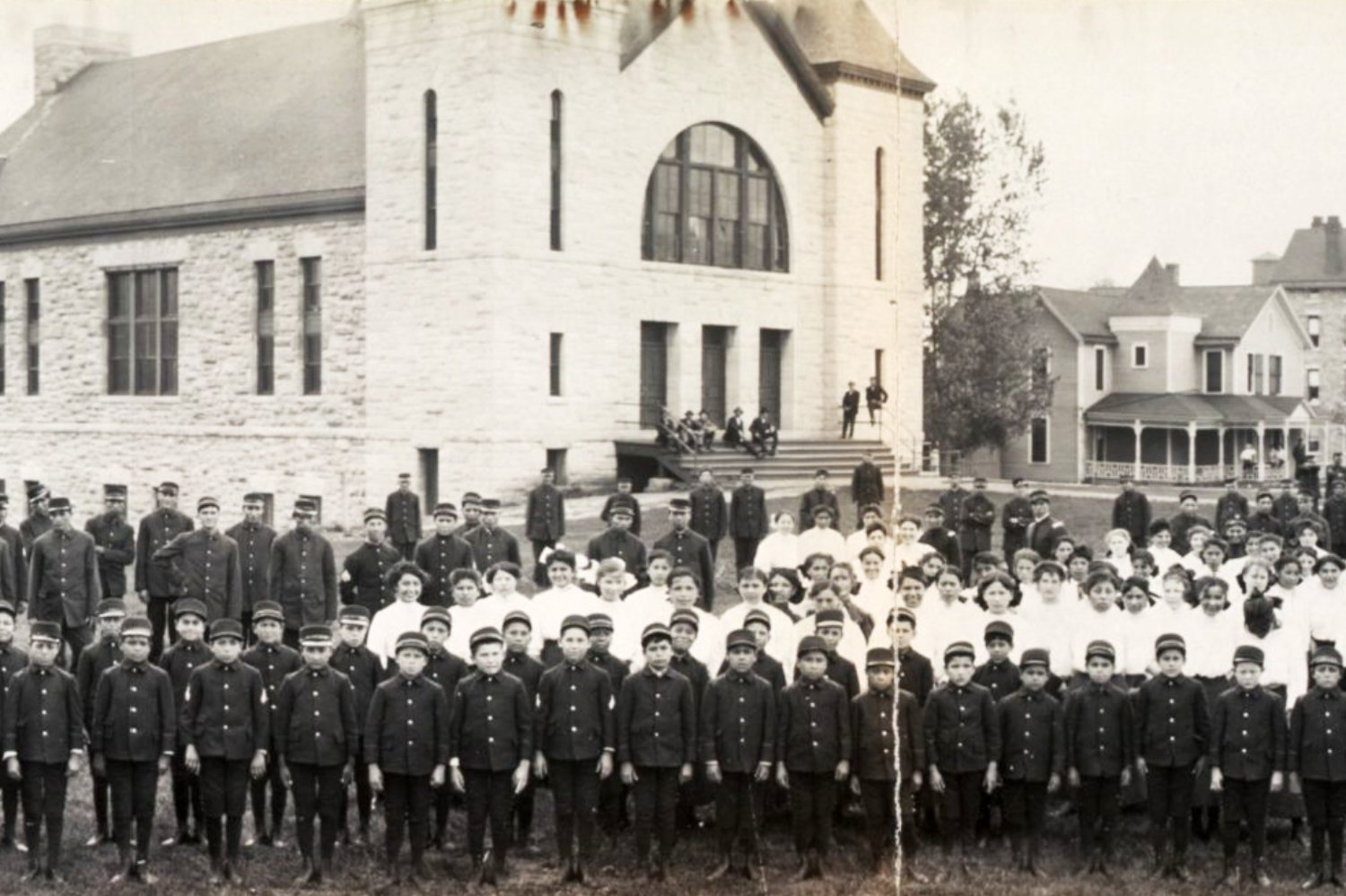 Why were Native American kids required to attend boarding schools?
